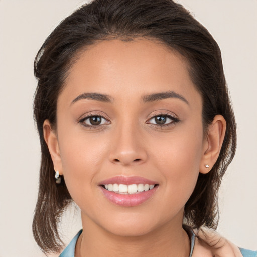 Joyful white young-adult female with long  brown hair and brown eyes