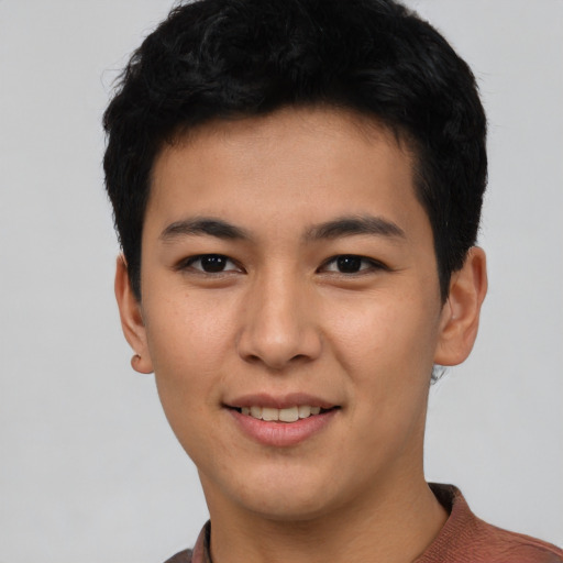 Joyful asian young-adult male with short  black hair and brown eyes