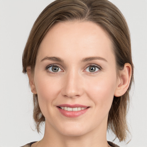 Joyful white young-adult female with medium  brown hair and grey eyes