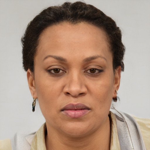 Joyful black adult female with short  brown hair and brown eyes