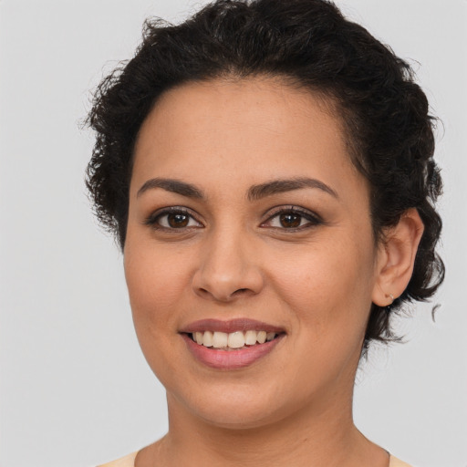 Joyful latino young-adult female with short  brown hair and brown eyes