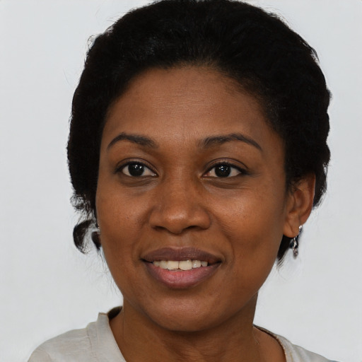 Joyful black adult female with short  black hair and brown eyes