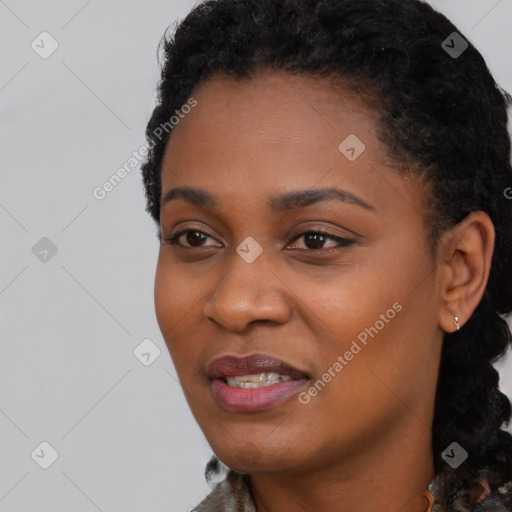 Joyful black young-adult female with short  black hair and brown eyes