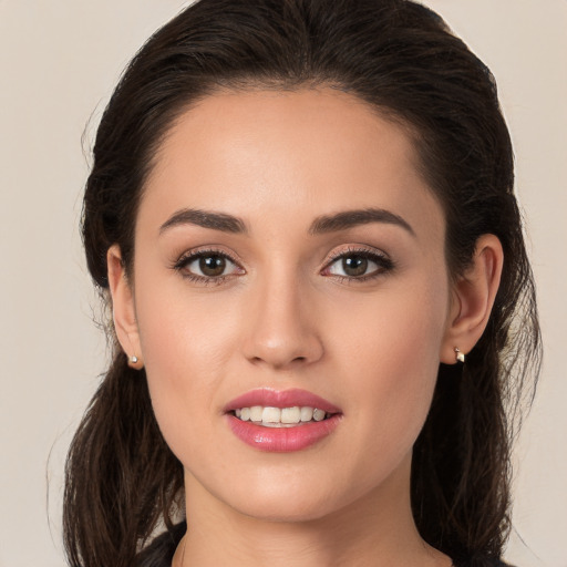 Joyful white young-adult female with long  brown hair and brown eyes