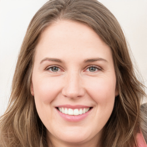 Joyful white young-adult female with long  brown hair and green eyes