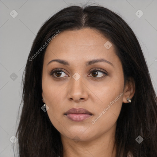 Joyful latino young-adult female with long  brown hair and brown eyes