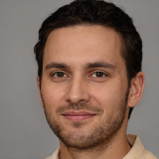 Joyful white young-adult male with short  brown hair and brown eyes