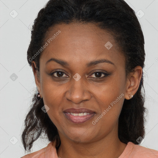 Joyful black adult female with long  brown hair and brown eyes