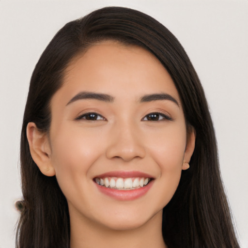 Joyful white young-adult female with long  black hair and brown eyes