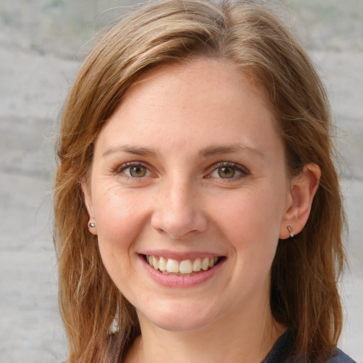 Joyful white young-adult female with long  brown hair and blue eyes