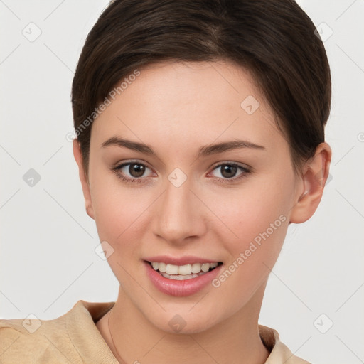 Joyful white young-adult female with short  brown hair and brown eyes