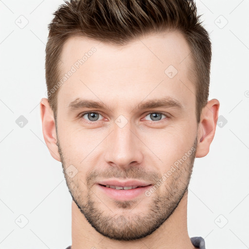 Joyful white young-adult male with short  brown hair and grey eyes