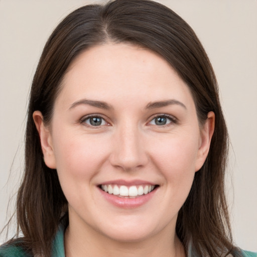 Joyful white young-adult female with long  brown hair and grey eyes