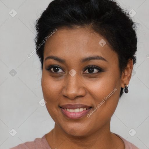 Joyful black young-adult female with short  black hair and brown eyes