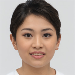 Joyful asian young-adult female with short  brown hair and brown eyes