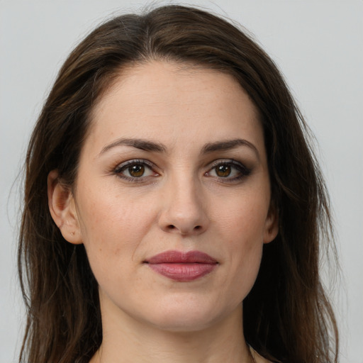 Joyful white young-adult female with long  brown hair and brown eyes