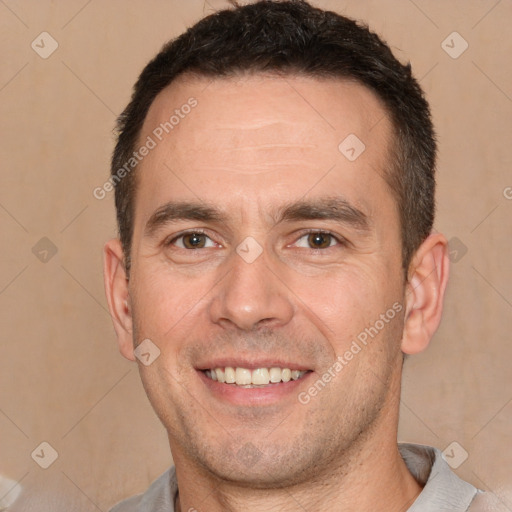 Joyful white adult male with short  brown hair and brown eyes