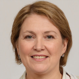 Joyful white adult female with medium  brown hair and grey eyes