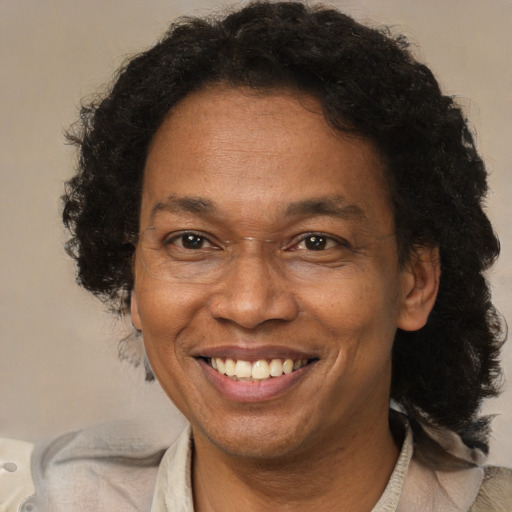 Joyful black adult female with short  brown hair and brown eyes