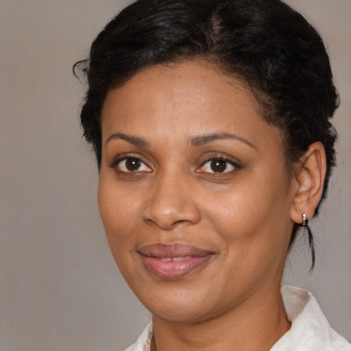Joyful black adult female with medium  brown hair and brown eyes
