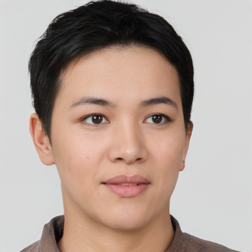 Joyful asian young-adult female with short  brown hair and brown eyes