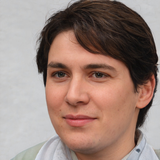 Joyful white young-adult male with medium  brown hair and brown eyes