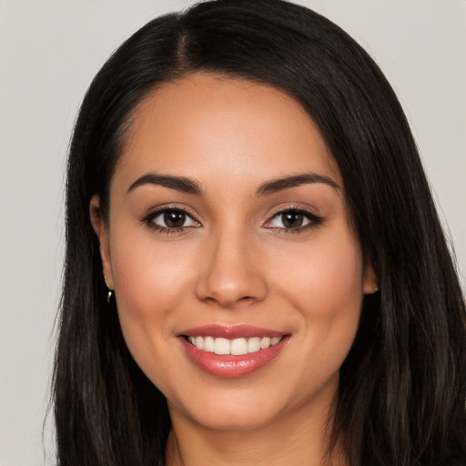 Joyful white young-adult female with long  black hair and brown eyes