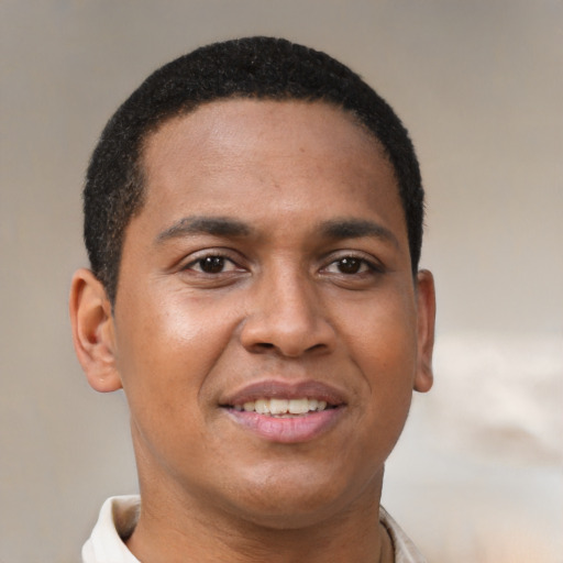 Joyful black young-adult male with short  brown hair and brown eyes