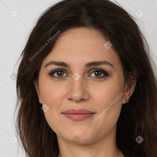 Joyful white adult female with long  brown hair and brown eyes