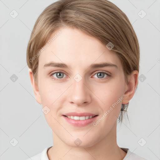 Joyful white young-adult female with short  brown hair and grey eyes