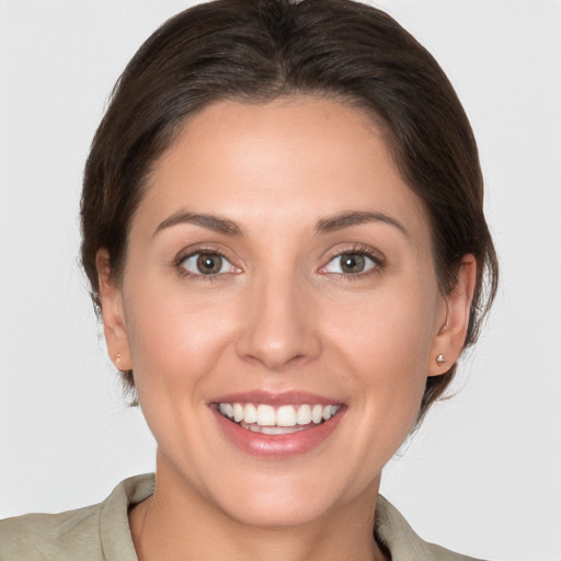 Joyful white young-adult female with medium  brown hair and brown eyes