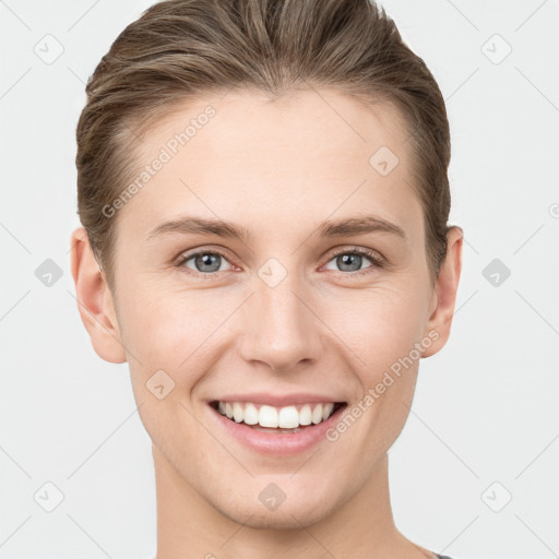 Joyful white young-adult female with short  brown hair and grey eyes