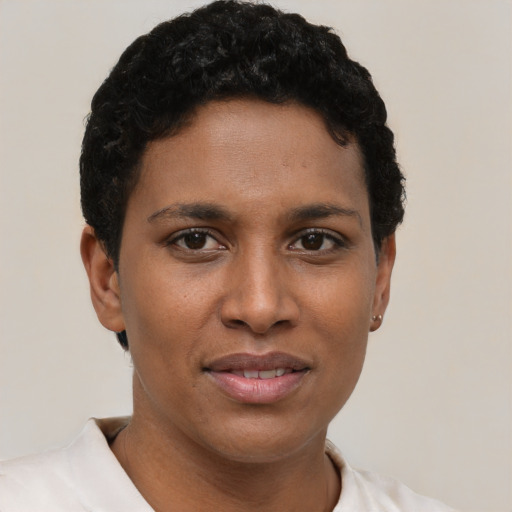 Joyful latino young-adult female with short  black hair and brown eyes