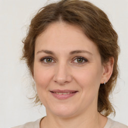 Joyful white young-adult female with medium  brown hair and green eyes