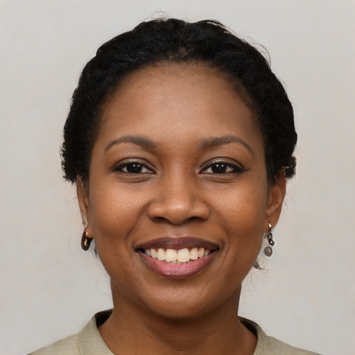 Joyful black young-adult female with medium  black hair and brown eyes