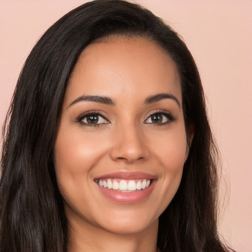 Joyful white young-adult female with long  brown hair and brown eyes