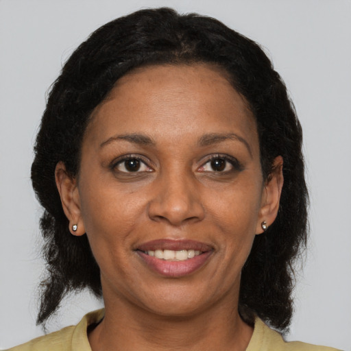Joyful latino adult female with medium  brown hair and brown eyes