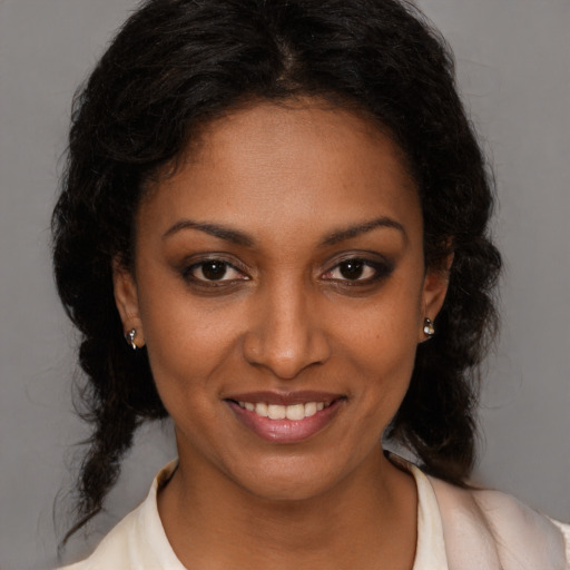 Joyful black young-adult female with medium  brown hair and brown eyes