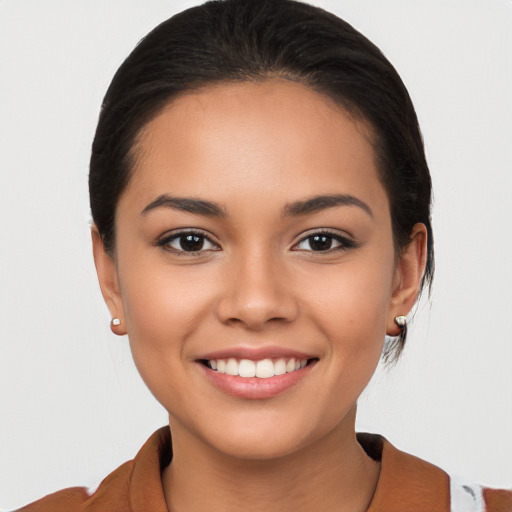 Joyful latino young-adult female with medium  brown hair and brown eyes