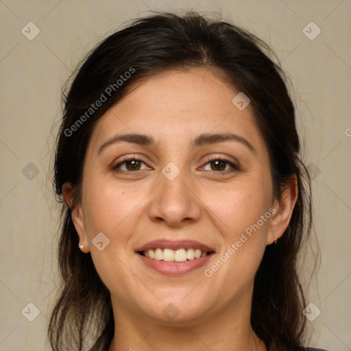 Joyful white adult female with long  brown hair and brown eyes