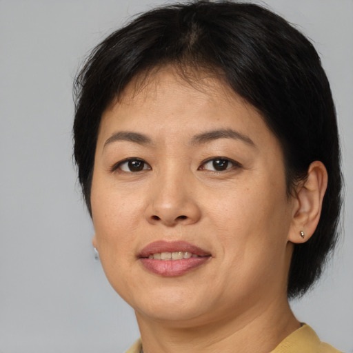 Joyful asian adult female with short  brown hair and brown eyes