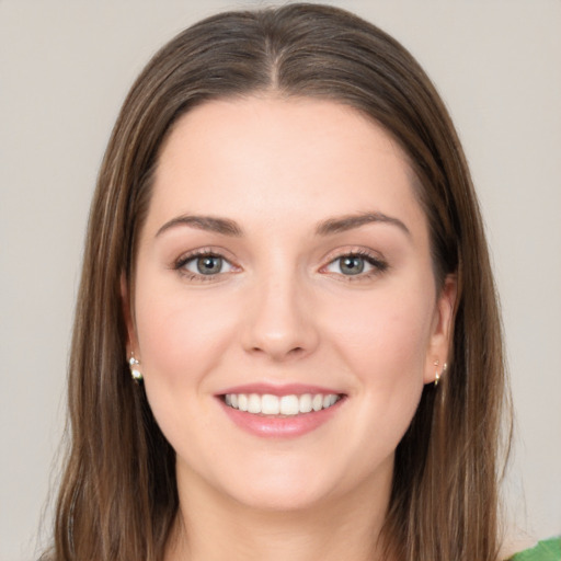 Joyful white young-adult female with long  brown hair and green eyes