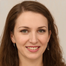 Joyful white young-adult female with long  brown hair and green eyes