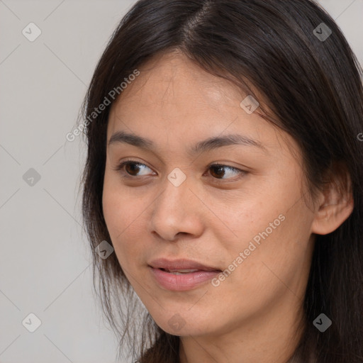 Joyful white young-adult female with long  brown hair and brown eyes