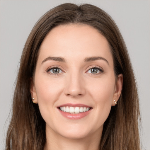 Joyful white young-adult female with long  brown hair and grey eyes