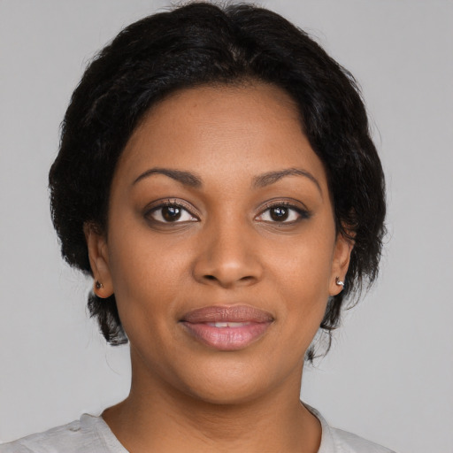 Joyful black young-adult female with medium  black hair and brown eyes