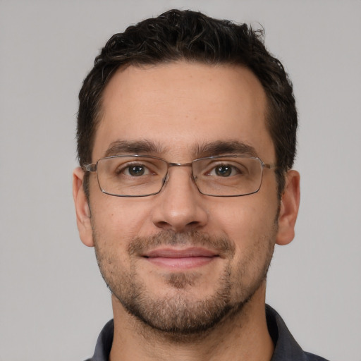 Joyful white adult male with short  brown hair and brown eyes