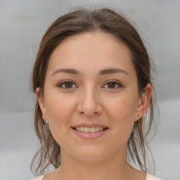 Joyful white young-adult female with medium  brown hair and brown eyes