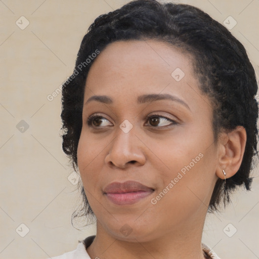 Joyful black young-adult female with medium  black hair and brown eyes