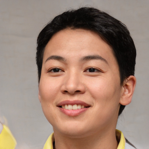 Joyful asian young-adult female with short  black hair and brown eyes